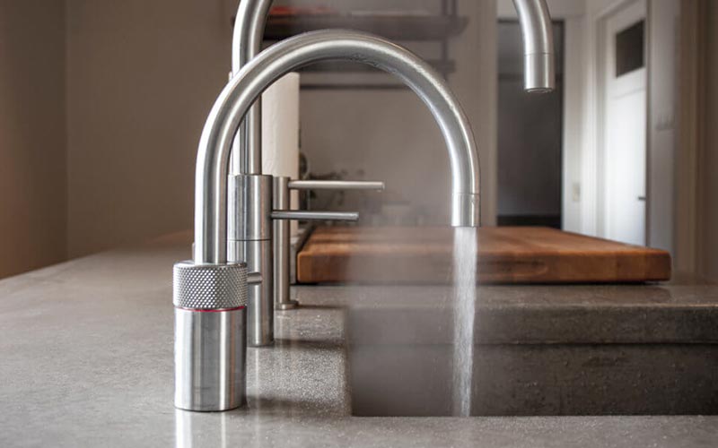 A row of boiler taps in a kitchen